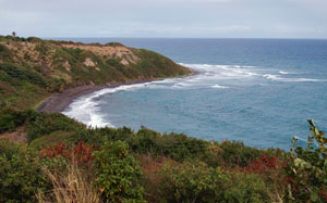 A view of a secluded black sand beach at St Kitts