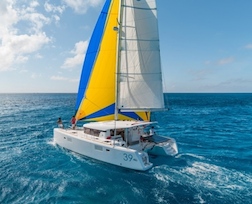 Sleek and stylish new Lagoon catamaran under sail in turquoise waters