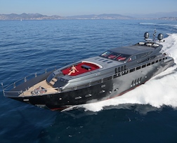 Dark and mysterious 34 metre luxury motor yacht cruising quickly through Mediterranean Waters