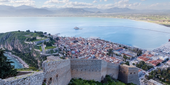 The beautiful historic port of Poros surrounded by the top charter yachts in the East Med